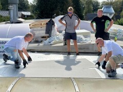 Applying fire-safe, ultra-light BarrierSheets to a newly insulated roof.