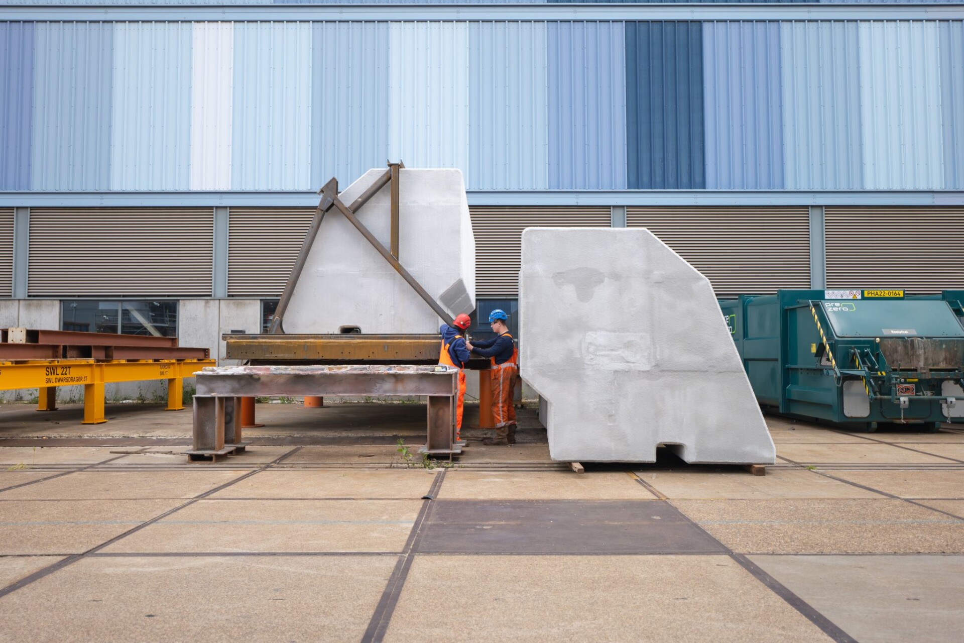 Construction workers inspecting a CoreShield-coated EPS panel at the Hollandia Infra fabrication site.