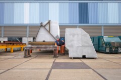 Construction workers inspecting a CoreShield-coated EPS panel at the Hollandia Infra fabrication site.