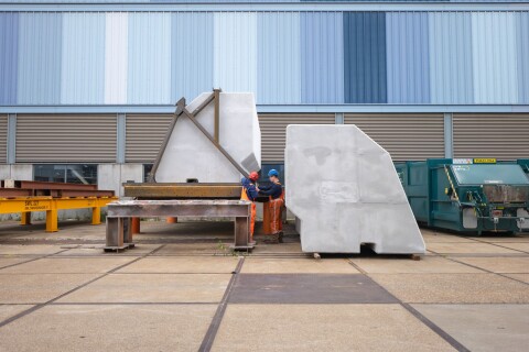Construction workers inspecting a CoreShield-coated EPS panel at the Hollandia Infra fabrication site.