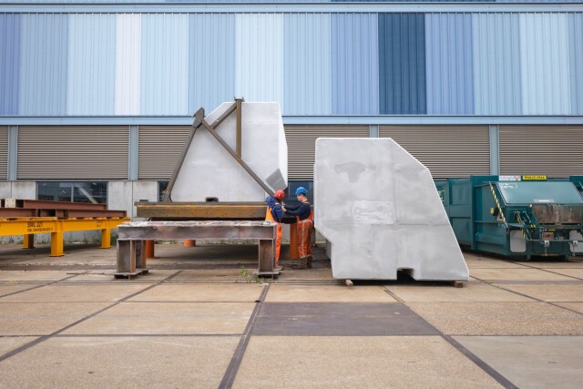 Construction workers inspecting a CoreShield-coated EPS panel at the Hollandia Infra fabrication site.