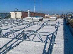 Roof at Kabeldistrict Delft treated with AllShield Blue fireproof coating, solar ballast frame at 15&deg; ready for panels