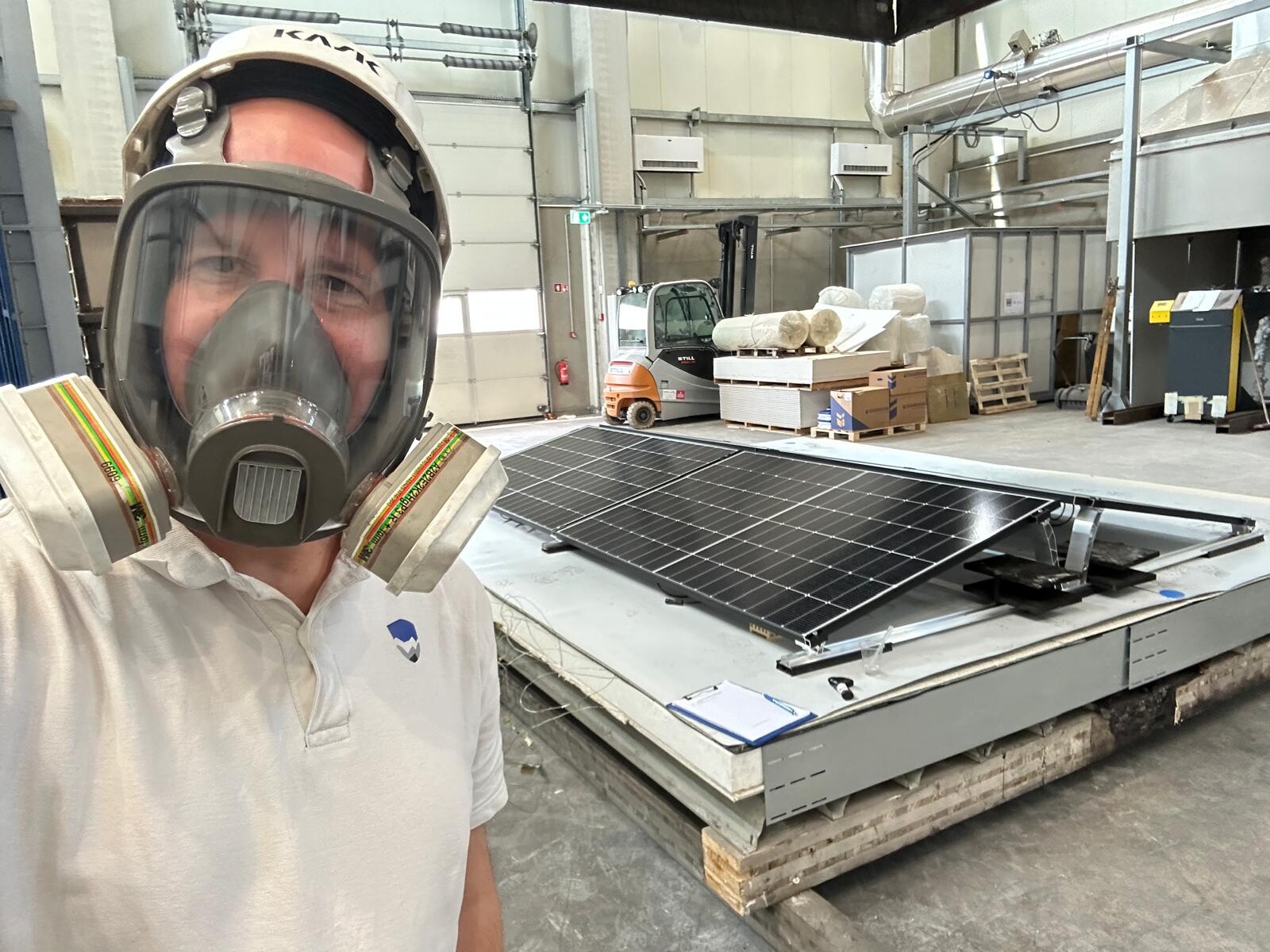 Olivier langejan next to a set up of a fire test for a commercial roof with PV wit a fire safe roof buildup